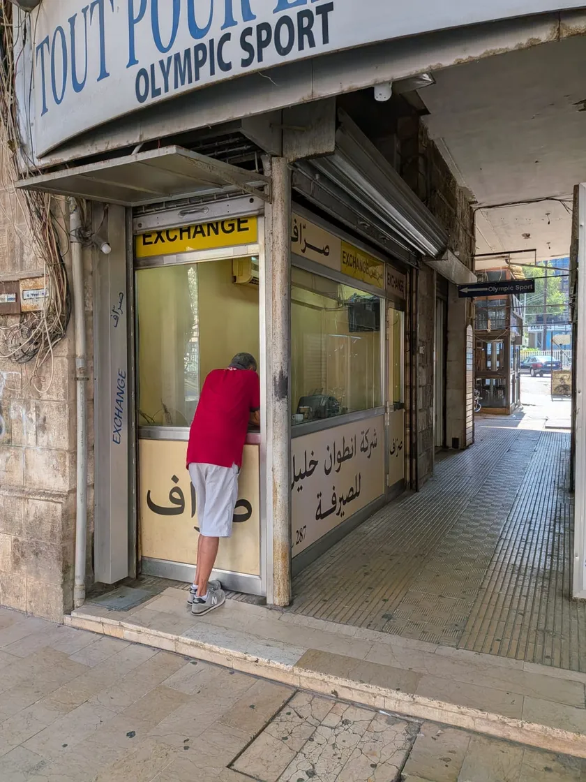 A customer at an exchange house counter, Lebanon, 2026